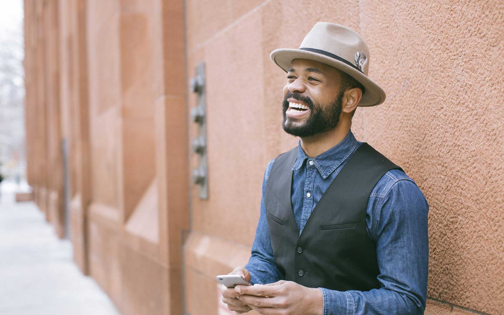 a happy man with beard and moustache showing perfect teeth in his smile