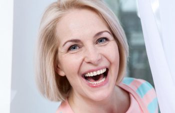 happy mature woman showing perfect teeth in her smile