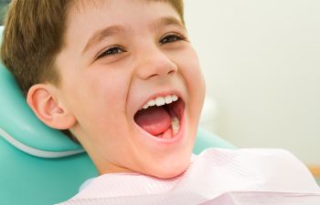 A joyful boy in a dental chair at Family Dentist in Rocky Hill, CT.