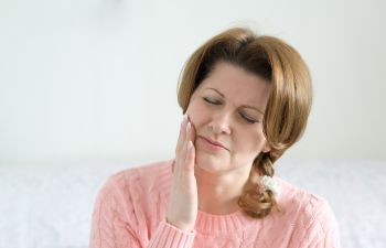 Woman suffering from dental pain.