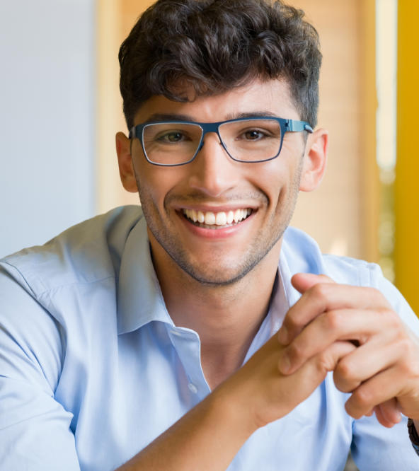 Cheerful man with glasses showing perfect teeth in his smile.