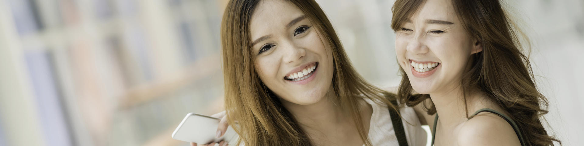 Two cheerful teenage girls with beautiful smiles.