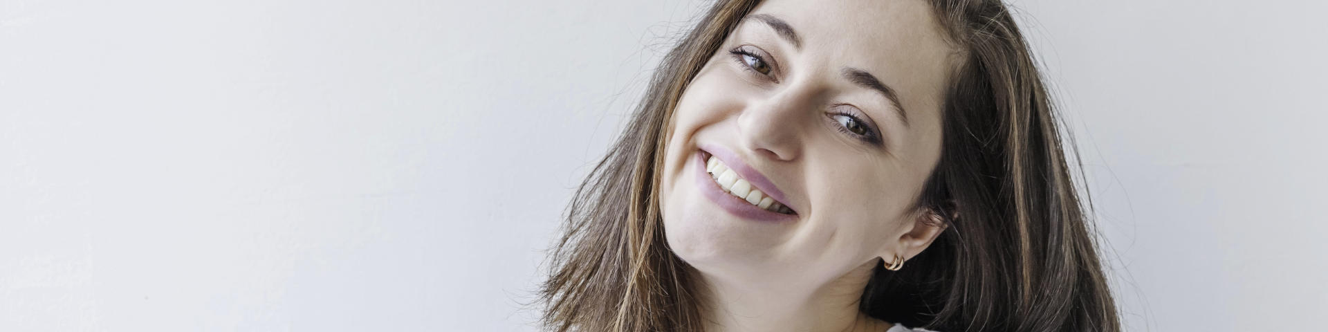 Happy woman showing her nice teeth in a smile.