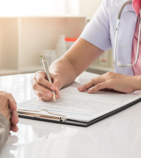 A patient and a doctor filling in patient's forms.