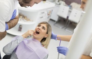 Man with severe dental pain in a dental chair waiting for the dentist.
