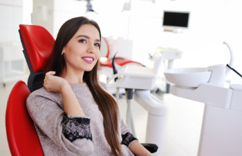 satisfied young woman in the dentist chair